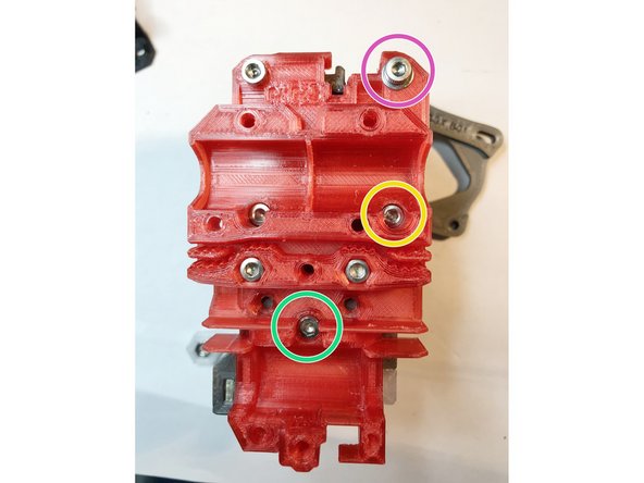 There are three critical length screws extending from back of x-carriage into extruder. Do not install them now, but remember these places to check during assembly later.