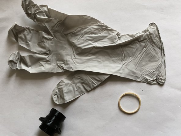 You will need a large or medium exam glove, rubber band, a bag penetrator flutter valve fitting, and valve deflector.