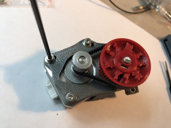 Rotate motor on its pivot bolt to take up belt slack. You don't need to make belt super taught like the X and Y belts. It simply needs slack removed.