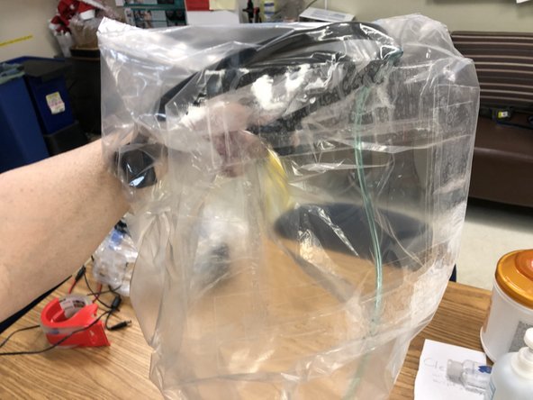 No viral filter is needed because inflowing gas is clean. A single expiratory valve contralateral to fresh gas flow is suggested. You must also wear a surgical mask because expiration is to room.