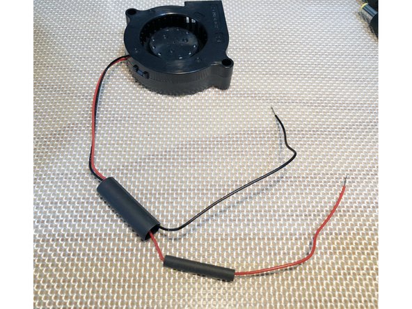 Place large diameter tubing over both positive and negative leads of fan leads.