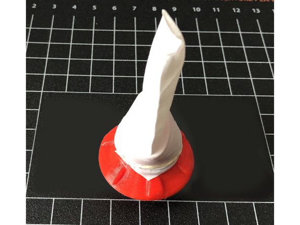 Ensure glove finger is advanced past the groove. Secure with a rubber band in the groove.