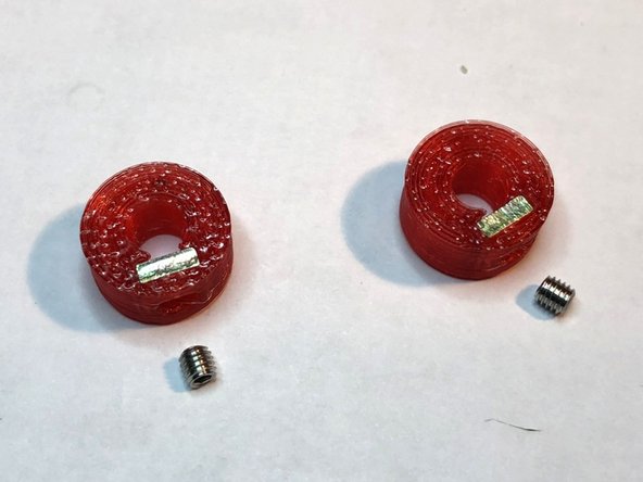 Embed M3 square nut and M3 x 3 mm set screw into each of two compact shaft locks