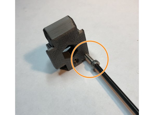 M3 x 12 mm filament sensor adjust screw directly threads into plastic of idler door. This is used to adjust internal filament sensor system. For now, advance its tip to just flush with inside surface of idler door.