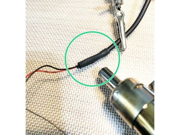 Insulate fan negative soldering joint with larger heat shrink tubing. This larger tubing will also cover inner shrink wrap