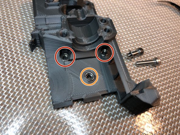 Install three M3 nuts. These will attach extruder to x-carriage.