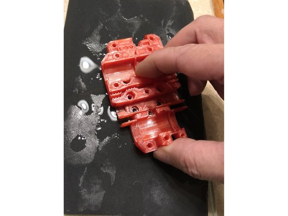 Wet lap mating surface of carriage flat with 600 wet/dry sandpaper on glass plate. Don't change dimensions, just flatten high spots, especially if printed on textured sheet.