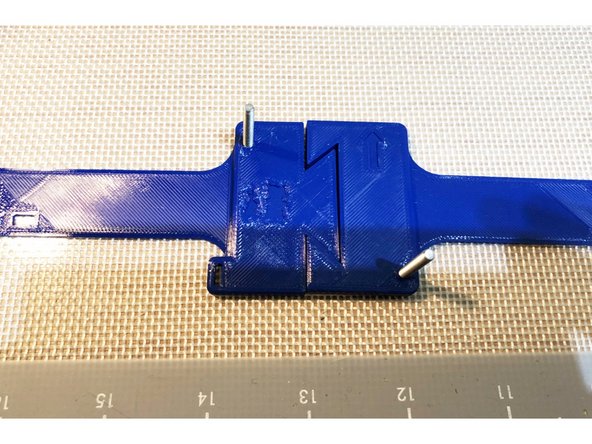 Bunny PAPR Flex Fit places fan on top of head via a banded mount. (Band is in two halves so can fit print plate)