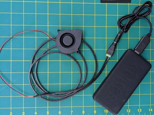 USB battery pack can also be used if combined with a DC converter to boost voltage from 5 volts to the fan's required 12 volts.