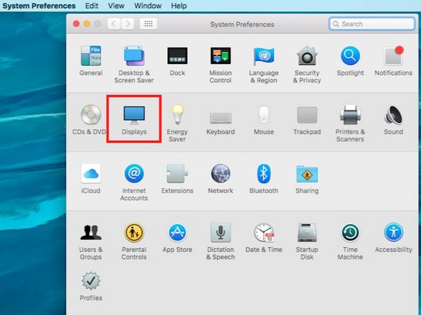 After the video cable is connected, open System Preferences and then the Displays Preference Pane on the Mac.