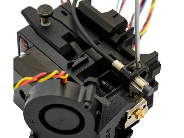 Insert the pinda into its mounts and fasten it with a M3x16mm Flat Head-Head Socket Cap Screw at the level of the nozzle.