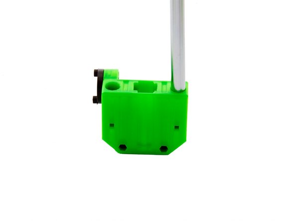 Place one of the 380mm x-Rods into one of the designated holes. Carefully tap the rod into the x-idler with a soft-faced hammer.