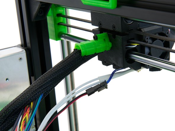 Push all the cables and the nylon filament through the Techflex tube you just prepared. Here, the end of the tube with the cut-out rectangle must be directed at the extruder.
