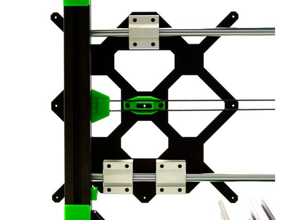 Align the y-belt tensioner in such a way that the belt runs centrally through the opening in the belt holder. Then tighten the 2x M6x12mm Hexagon Socket Head Cap Screws on the y-belt tensioner.