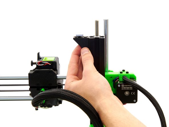 Slide one of the corner brackets into the right slot of the left z-extrusion so that the end of the extrusion and the corner bracket are level.