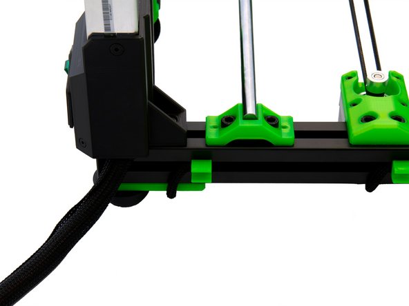 Press the Techflex tube with the PSU cables into the cable clips already attached to the back of the x-extrusion.