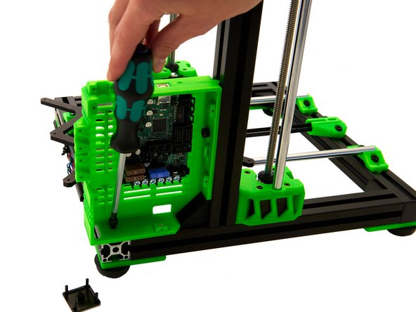 Align the remaining T-Nut inside the rear x-extrusion with the hole on the bottom of the Einsy Box. Into this hole, you place another M6x12mm Hexagon Socket Head Cap Screw and tighten it.