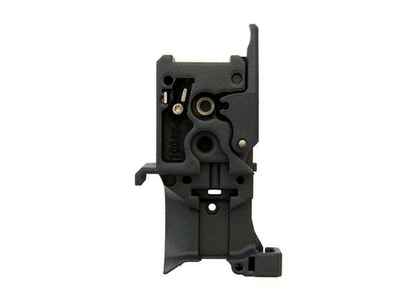 Insert the long magnet into the slot to the left of the lever.