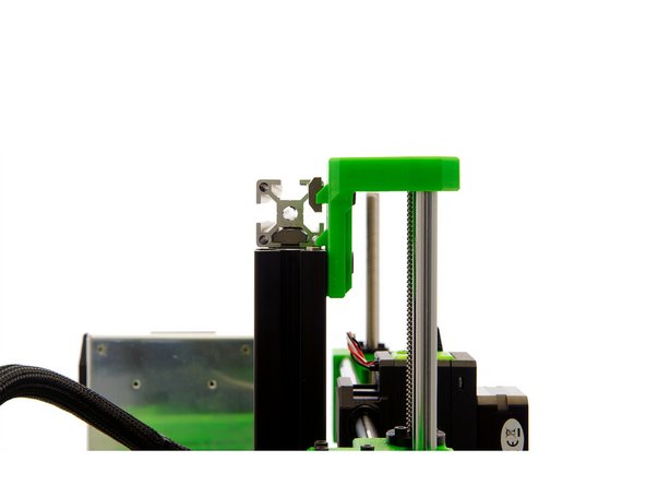 Carefully position the left hole in the z-top mount over the z-rod.