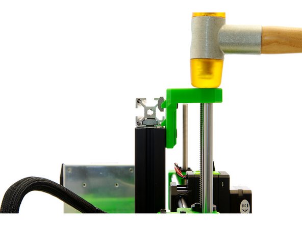 Gently tap the z-top mount with a hammer so that it is at the same height as the z-axis.