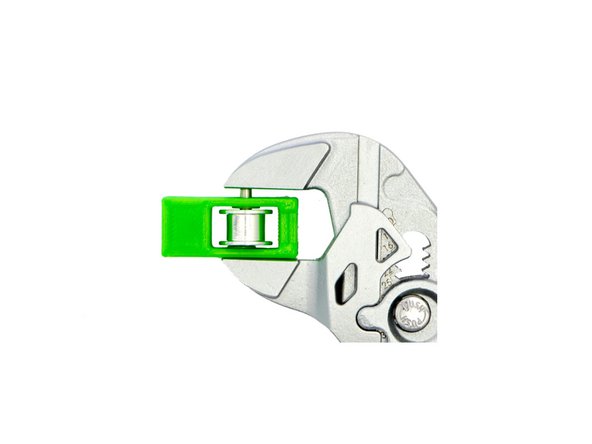 Place a M3 Plastic Washer on the toothless pulley and, with the pliers wrench, push the dowel pin as far as possible through the opening of the xy-belt tensioner insert (Fig. 2)