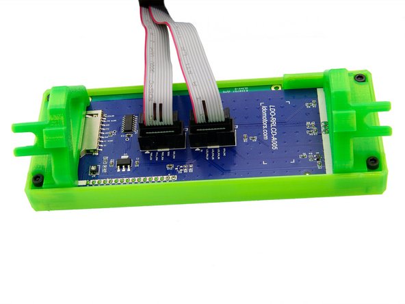 First, plug the two ribbon cables into the connectors on the back of the display.