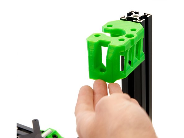 Slide the z-motorholder (the opening must face inwards) into the front slot of the z-extrusion. Then, press the z-motorholder onto the y-extrusion so that it rests straight on it.