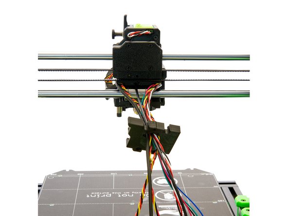 After that, pass the pinda cable, the filament sensor cable, the motor cable, the two fan cables and finally the nylon through the hole in the center of the x-carriage back (bottom).