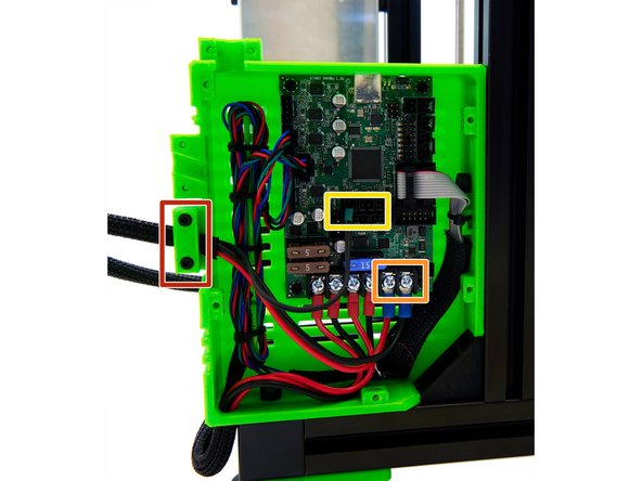 Place the end of the Techflex tube, with the heatbed cables and heatbed thermistor, into the lower cable guide on the left side of the Einsy Box.