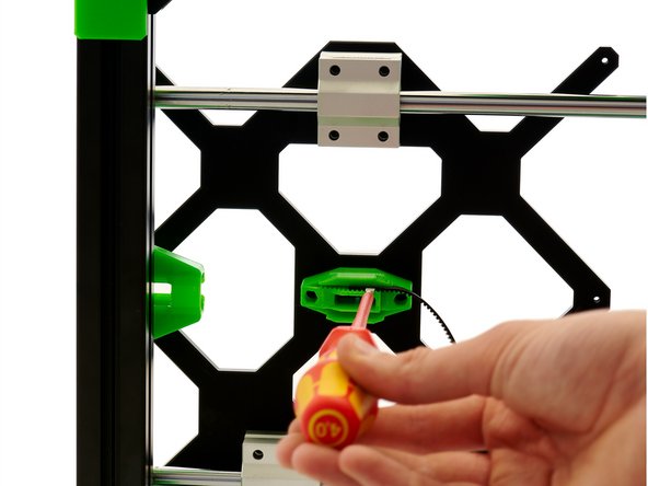 Turn your frame over and press the belt into it on the bottom half of the belt holder.