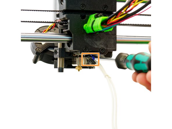 Insert the heater cartridge into the lower opening and the thermistor into the upper opening in the hotend. Secure both with a (previously removed) M2x5mm Hexagon Socket Head Cap Screw.