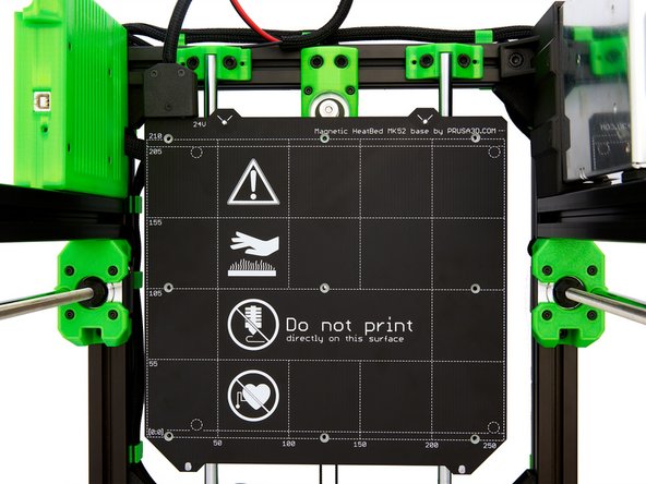 Carefully place the heatbed on the spacers. Then, check the positions of the spacers under the heatbed.