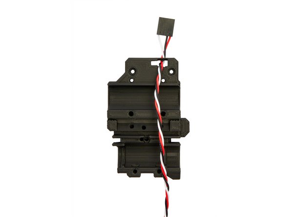 Feed the filament sensor cable connector through the top slot in the x-carriage (Fig. 1).
