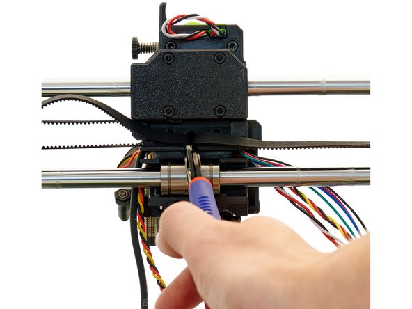 Now, guide the belt back to the x-carriage. If the two belt ends are overlapping in the middle, cut the protruding end.