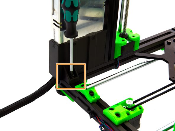 Align the remaining T-Nut in the rear x-extrusion with the hole on the bottom of the power supply. Place an M6x12mm Hexagonal Socket Head Cap Screw into this hole. Then tighten the screw.