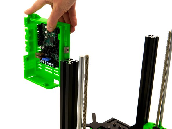 Attach the Einsy Box to the left side of the printer, using the T-Nut that was just attached. The T-Nut is pushed into the rear slot of the left z-extrusion.