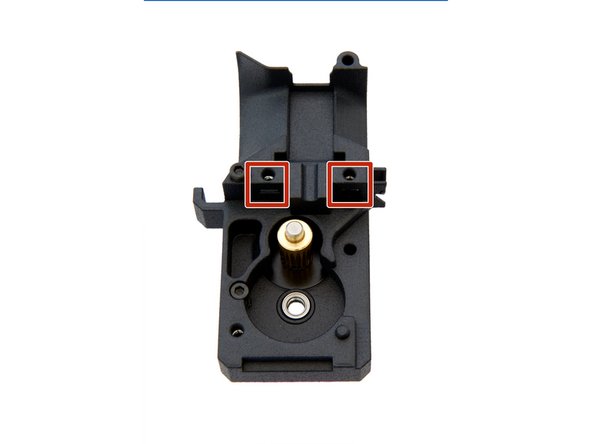 Insert a M3 Square Nut  into the hole, in the center of the extruder back. Make sure that the square nut is inside the left slot.