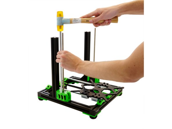 Place a z-rod in the hole next to the z-stepper motor on the z-motorholder . Carefully tap the z-rod straight into place.