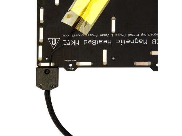 Place the Heatbed Cover Bottom onto the Heatbed Cover Top and ensure that the thermistor cable is routed through the slot in the Heatbed Cover Bottom.