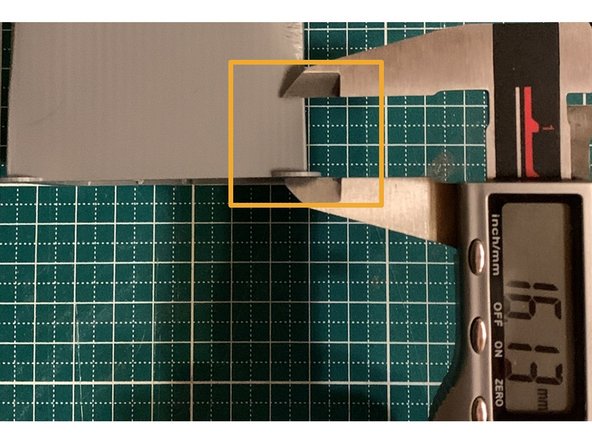 We use the caliper to measure the distance from the 1st layer to this area and note the value.