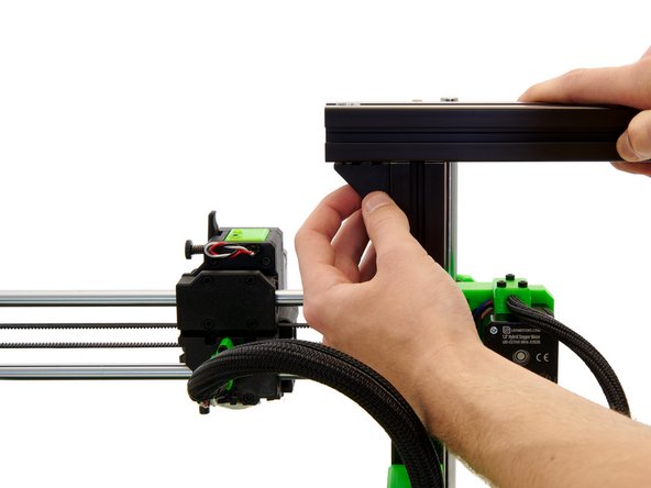 Push the x-extrusion through the two T-Nuts.