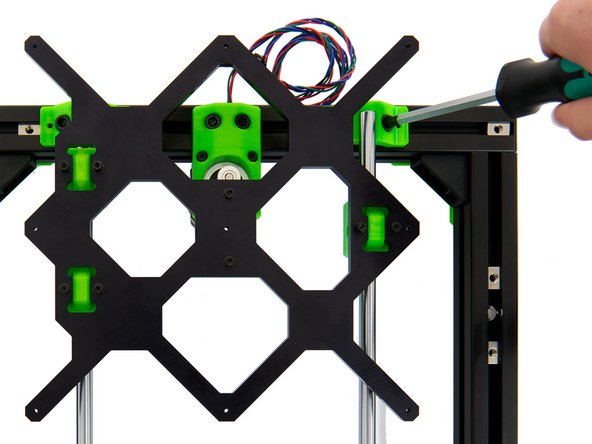 Move the y-carriage to the far rear and fasten the 2x M6x12mm Socket Head Cap Screws in the y-rod holder at the right rear.