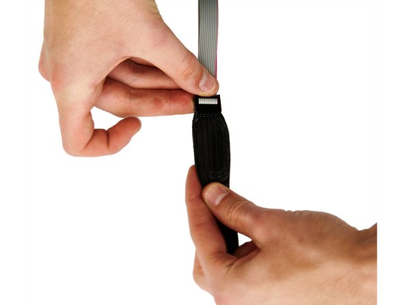 First, plug the two ribbon cables into the connectors on the back of the display.