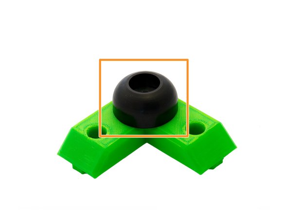 Turn the L-bracket over and place a rubber foot on it.