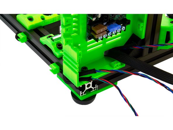 Now, guide the two Techflex tubes of the motor cables through the hole in the bottom of the Einsy Box.