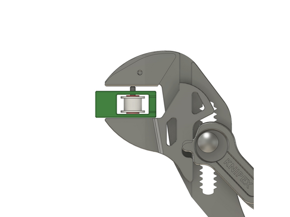 Legen Sie eine M3 Kunststoff Unterlegscheibe (rot dargestellt) auf die zahnlose Riemenscheibe und drücken sie den Passstift mit dem Zangenschlüssel soweit wie möglich durch die Öffnung des xy-Riemenspannereinsatzes (Bild 2)