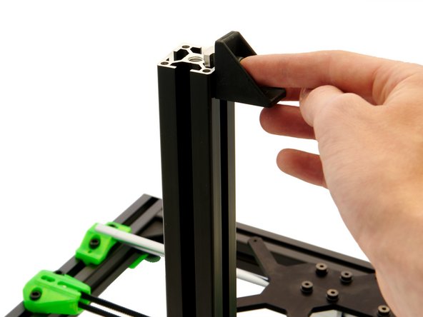 Slide a corner bracket into the rear slot of the z-extrusion.