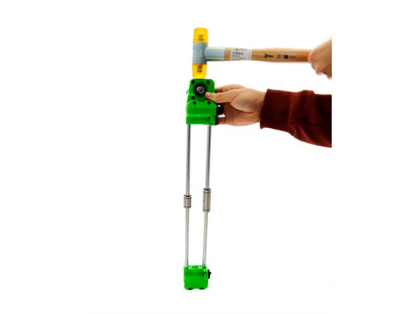 Align both x-rods with the holes in the x-idler and gently tap the x-idler with a soft-faced hammer.