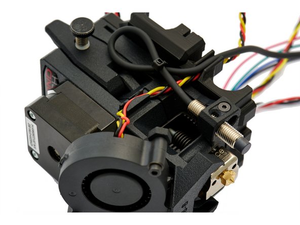 Run the cable along the extruder (as shown in Fig. 3) and secure it with a zip tie.