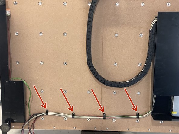 Tie the wiring down to the waste board(s) with the 4 x P-Clamps and 4 x 3x13mm Chipboard screws by screwing the chipboard screws into the waste board(s) with a phillips screw driver.  The wiring should run in a straight line from the Electronics Assembly to the Front Plate.